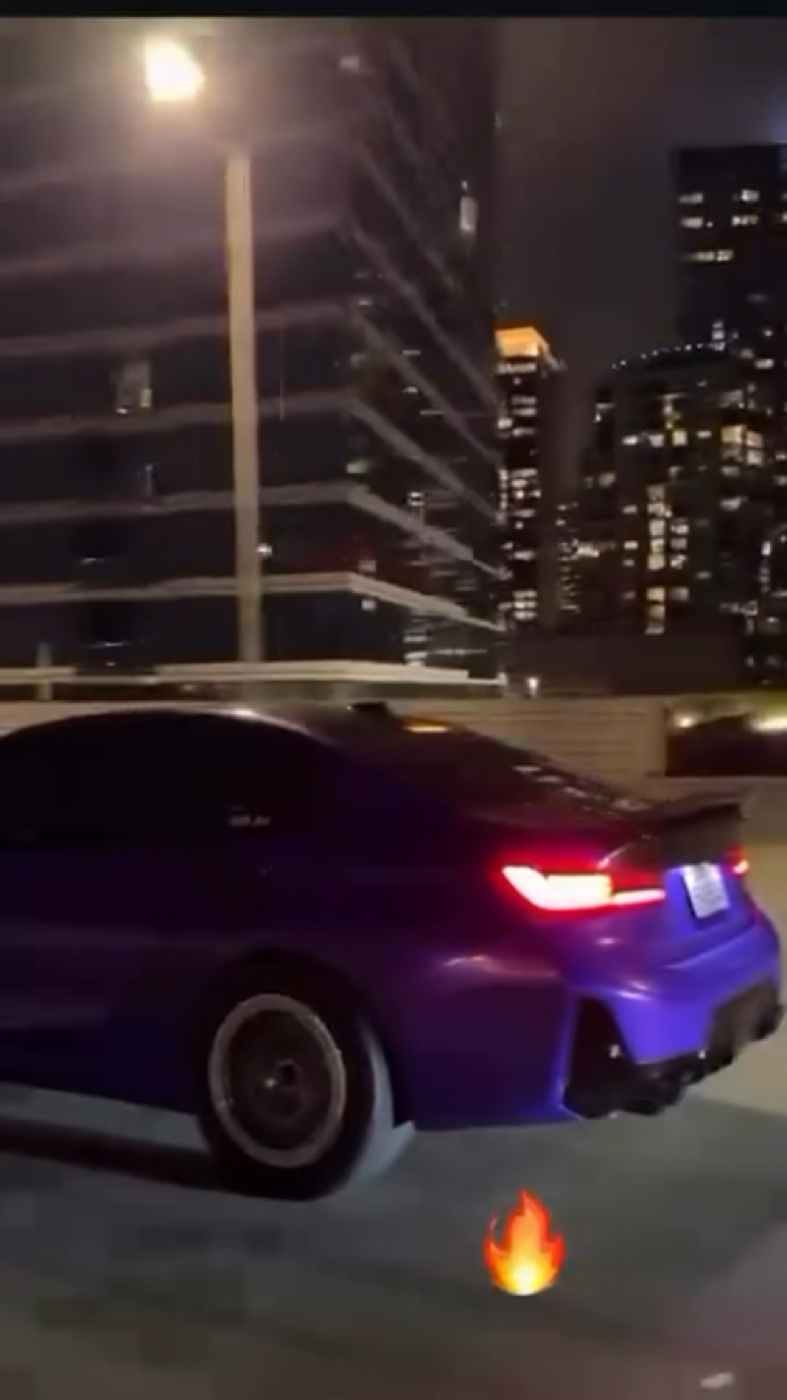 Blacked out BMW rolling through downtown Austin at night