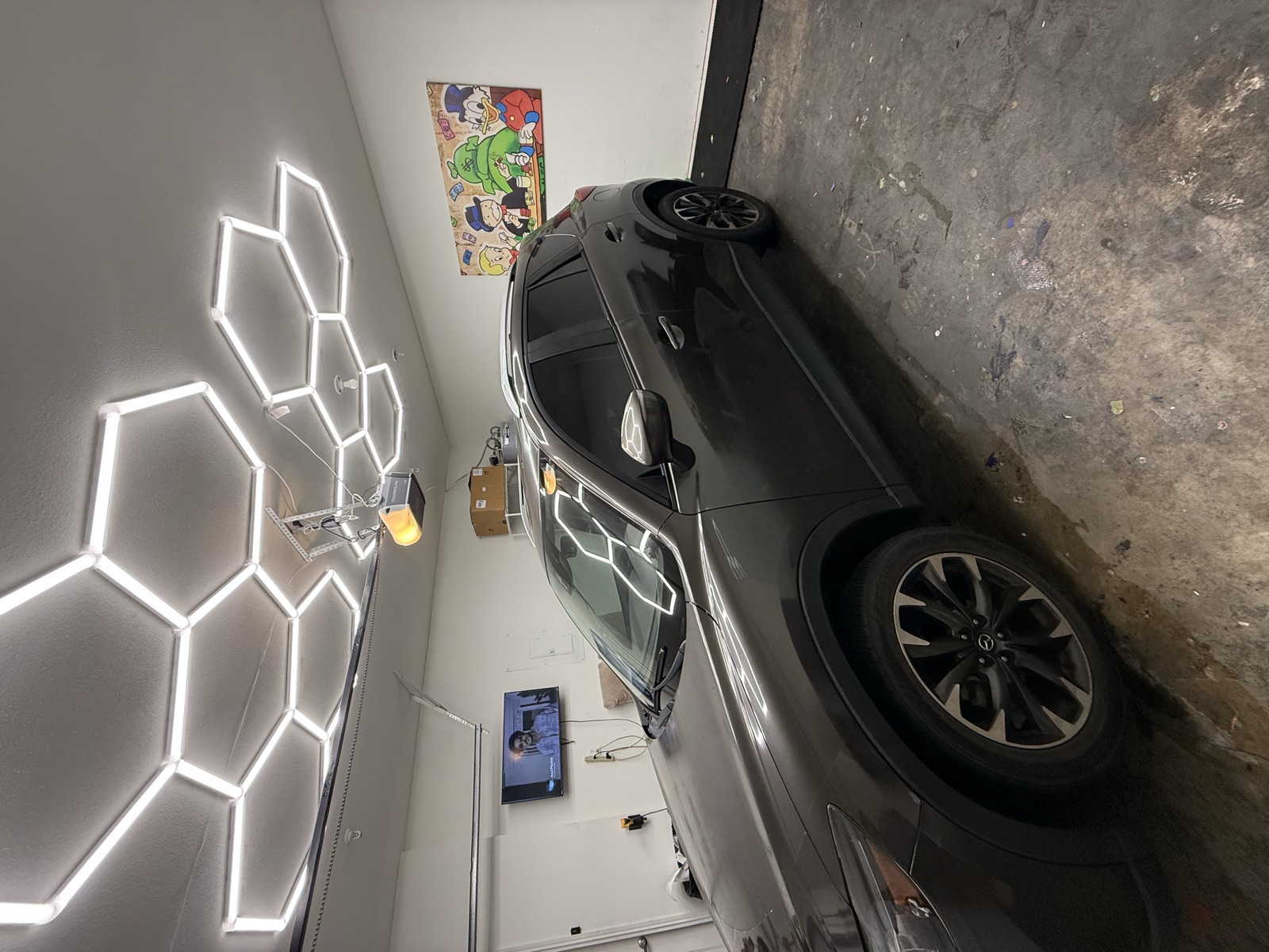 Freshly tinted Mazda under hexagon shop lights