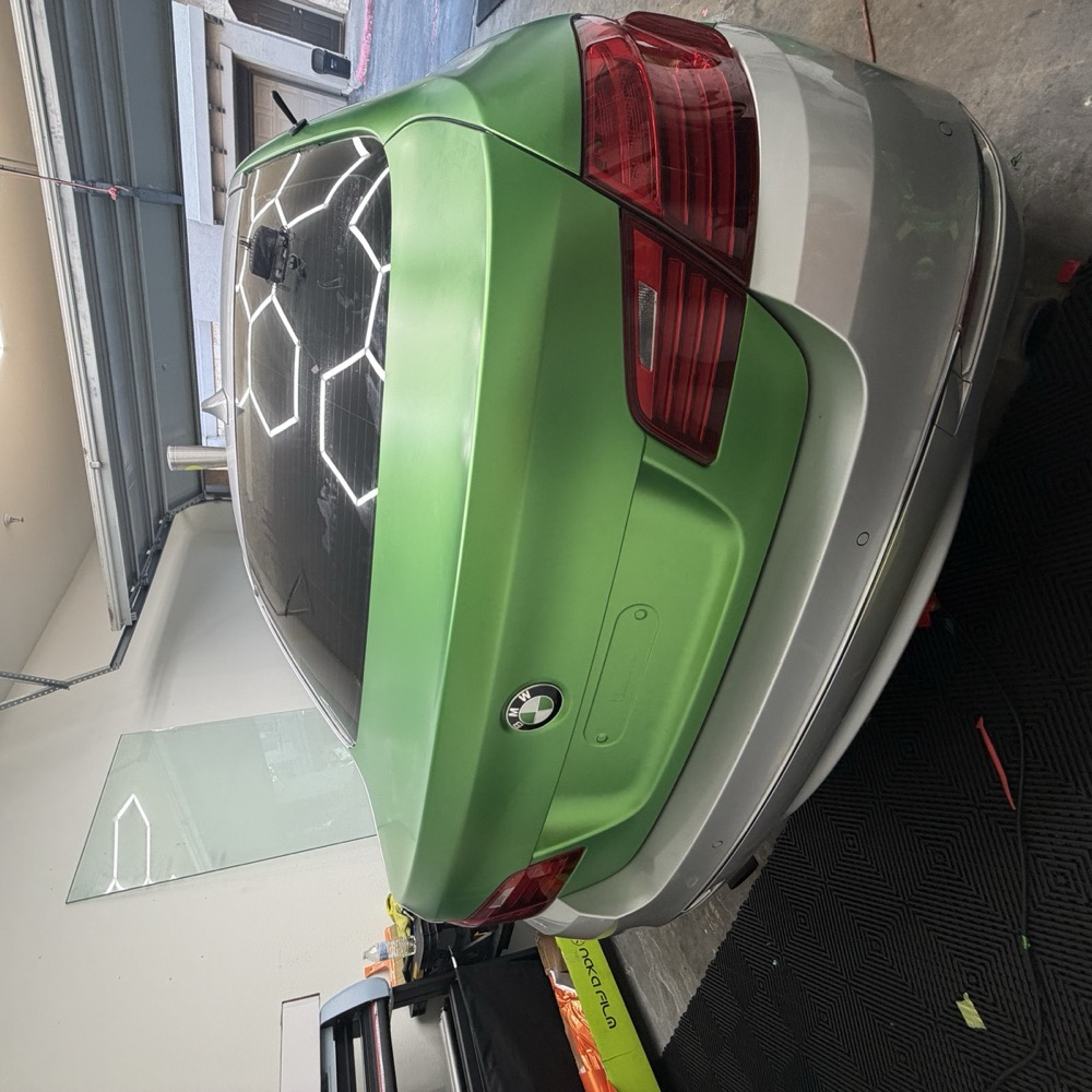 Same BMW after a satin green color change wrap by Detailz Plugg